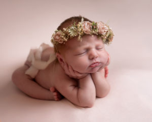 Newborn baby girl wearing flower crown
