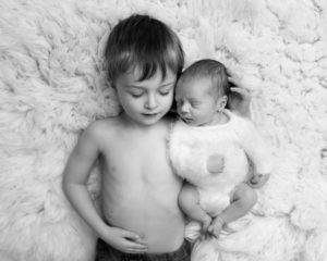 Big brother hugs his new baby brother