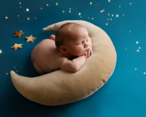 Baby boy sleeping with the moon and stars