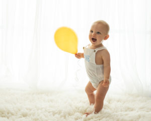 One year old baby boy with ballon