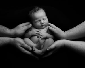 Newborn portrait in mum and dad's hands