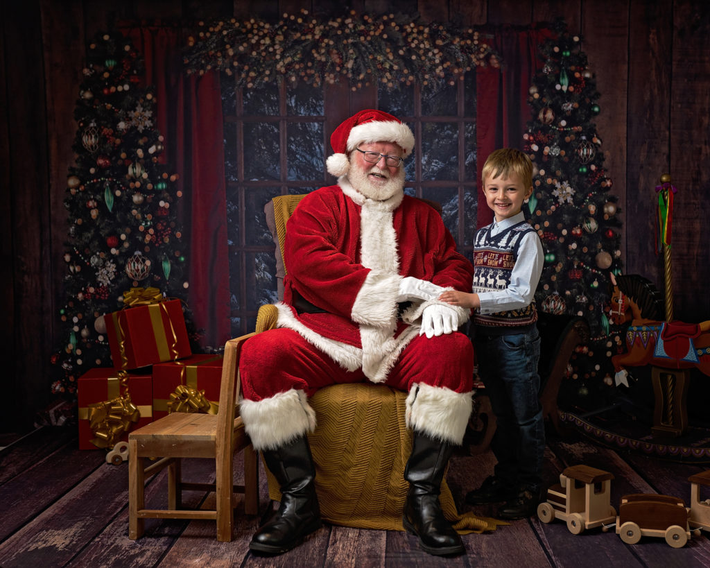 Smiling boy meets Santa at Wirral's premier Father Christmas Experience