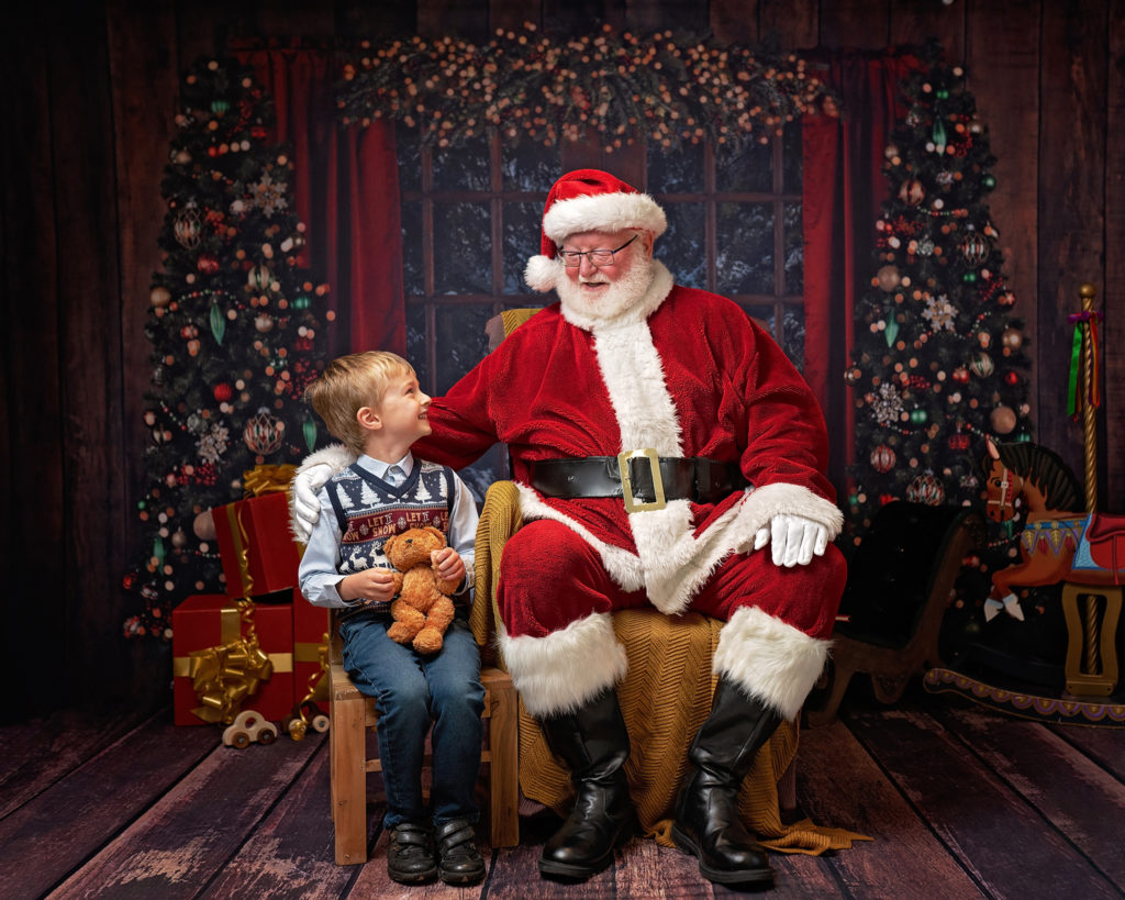 Boy holding Teddy bear at Father Christmas grotto photoshoot Wirral