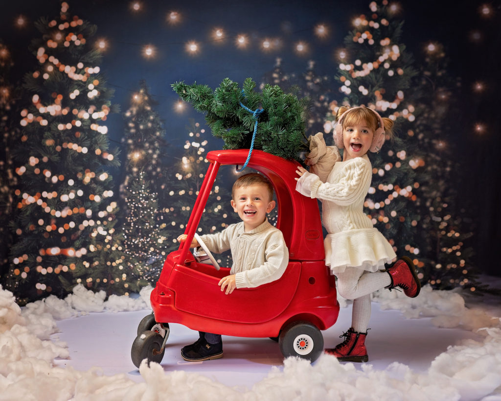 Boy and girl drive their car to the Christmas Tree Farm photoshoot at Slinky Photography Wirral
